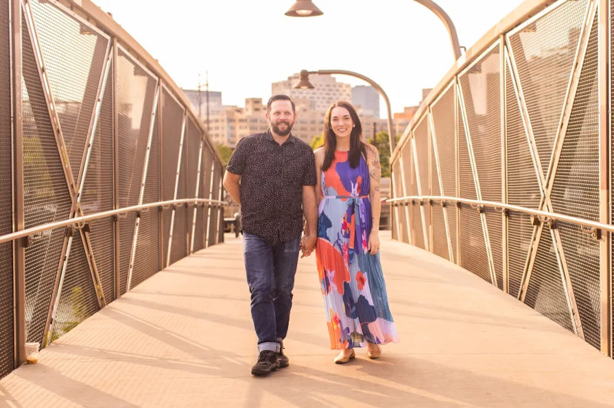 Two engaged folks on a bridge near Schuylkill River Park.