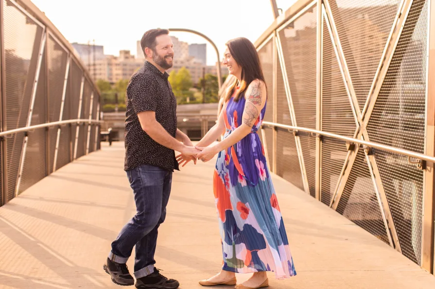 Two engaged folks on a bridge near Schuylkill River Park.