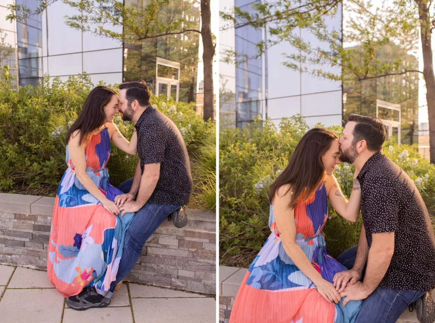 An engaged couple smiling and dancing in front of the Philadelphia skyline at Cira Green's rooftop .