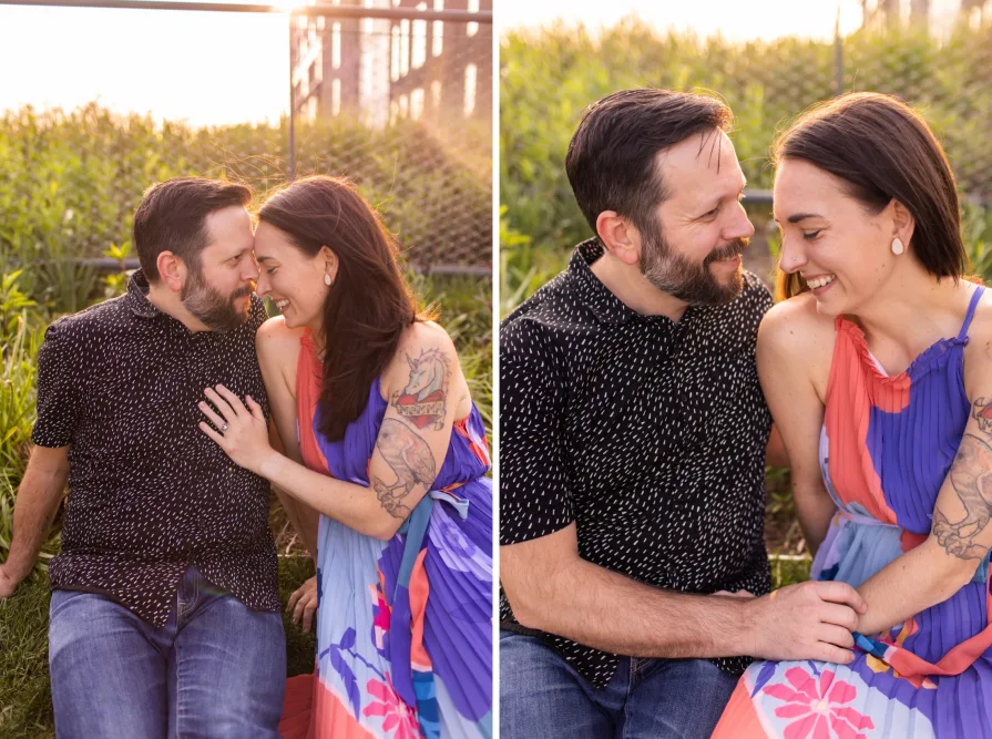 An engaged couple smiling and dancing in front of the Philadelphia skyline at Cira Green's rooftop .