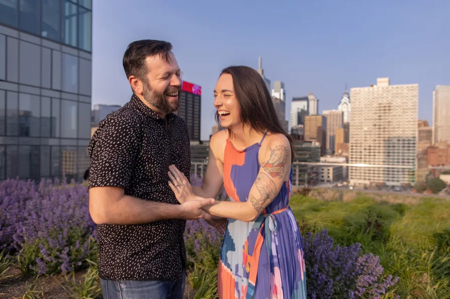 Engagement photos of a couple dancing on the Cira Green rooftop garden in Philadelphia.