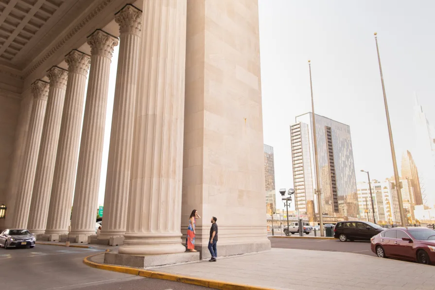 A wide photo of a couple outside of 30th Street Station.