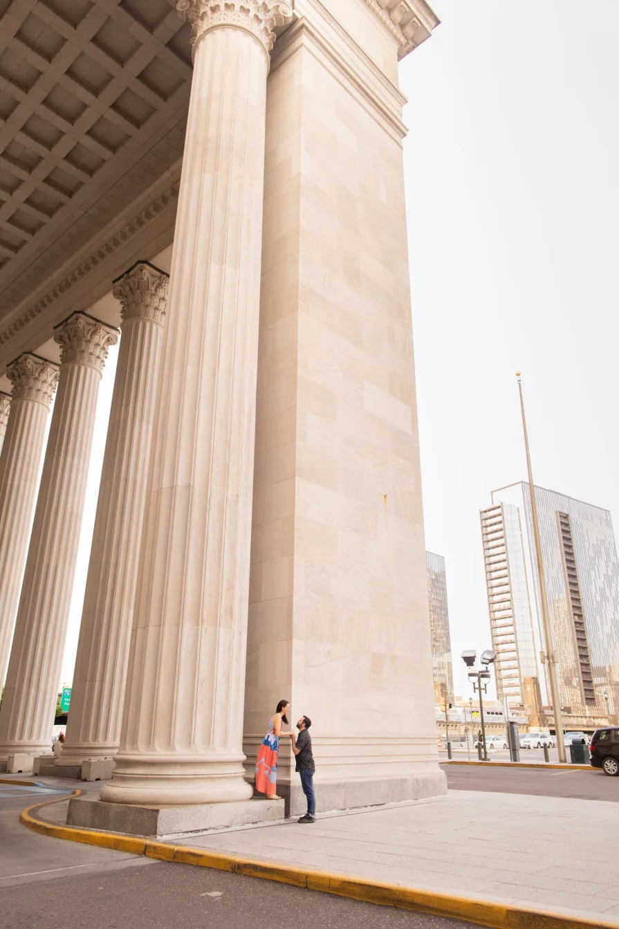 A wide photo of a couple outside of 30th Street Station.