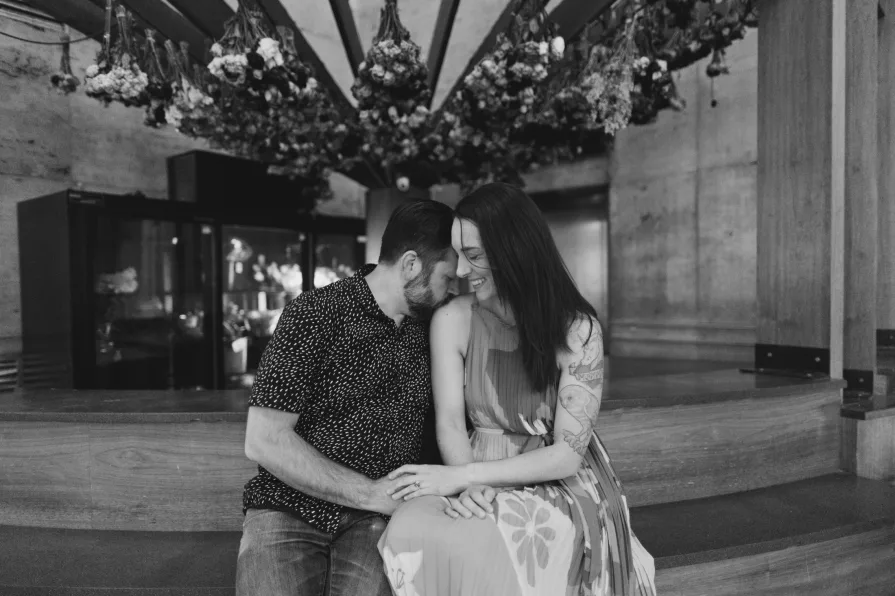 Black and white engagement photos inside 30th Street Station in Philadelphia.