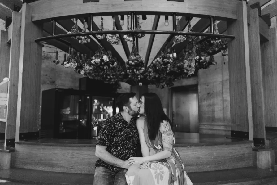 Black and white engagement photos inside 30th Street Station in Philadelphia.