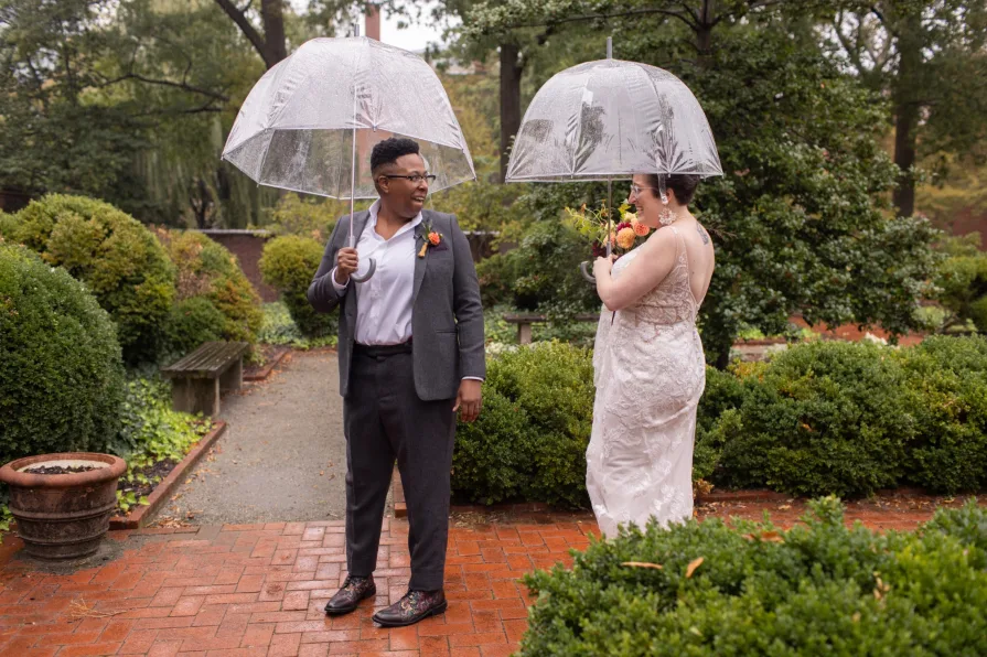 A queer, biracial couple in the rain for their first look in Philadelphia.