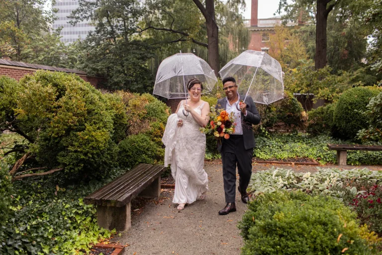 A queer, biracial couple in the rain for their first look in Philadelphia.