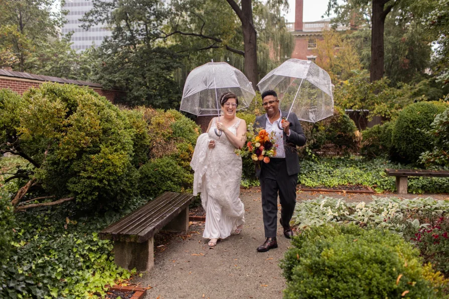A queer, biracial couple in the rain for their first look in Philadelphia.