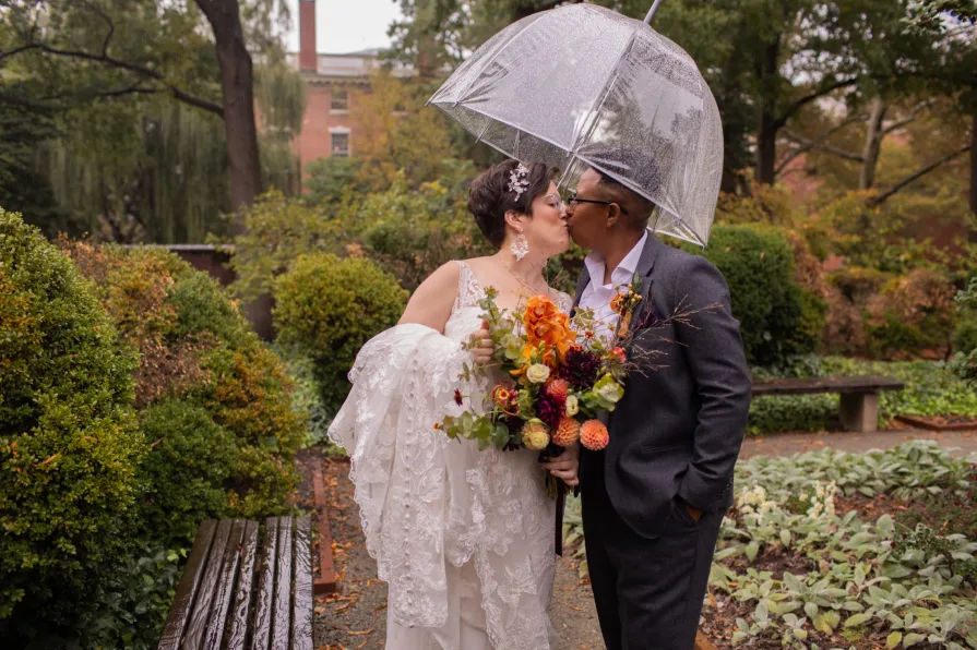 A queer, biracial couple in the rain for their first look in Philadelphia.