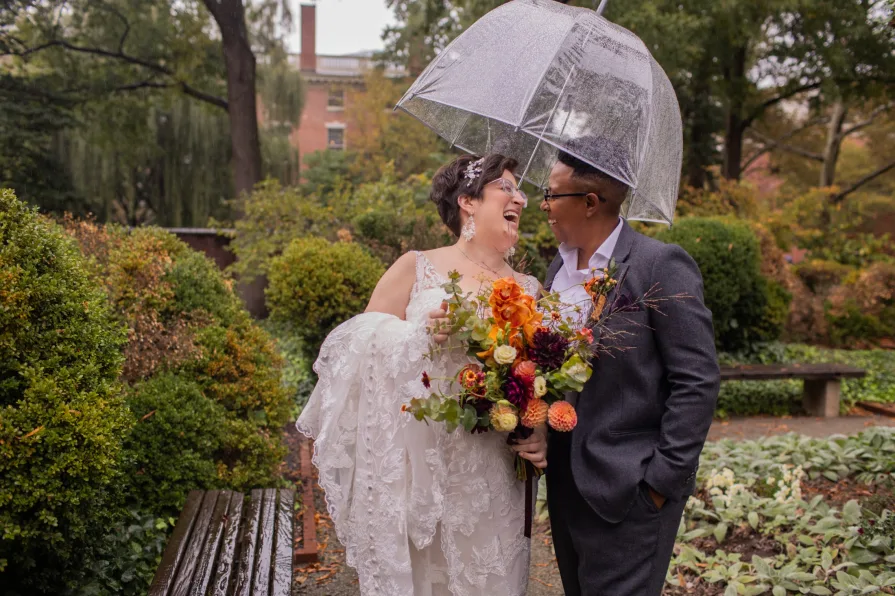 A queer, biracial couple in the rain for their first look in Philadelphia.