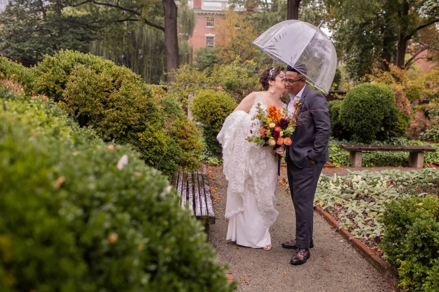 A queer, biracial couple in the rain for their first look in Philadelphia.