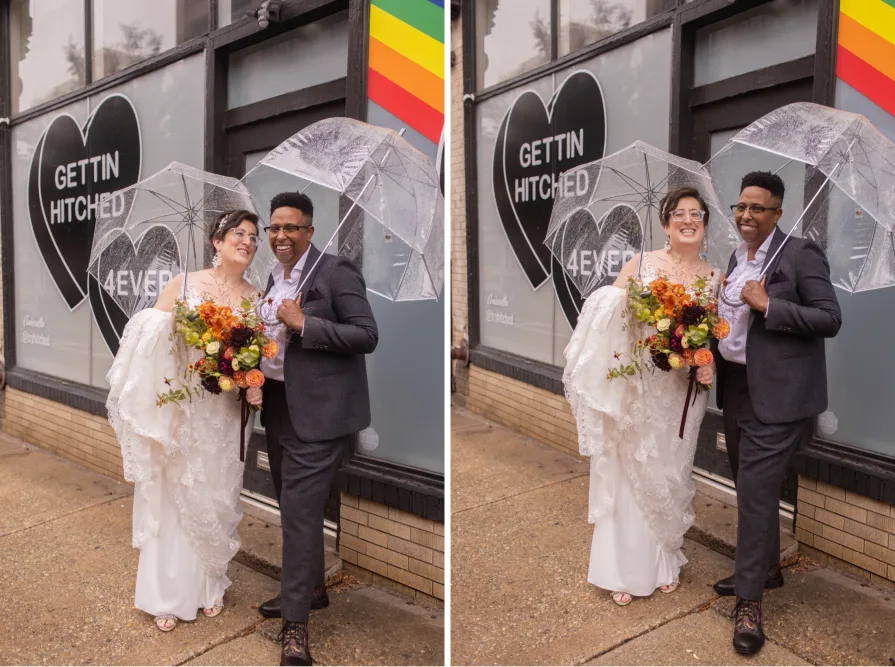 A queer, biracial couple in the rain on their wedding day in front of a Amberella XO mural.