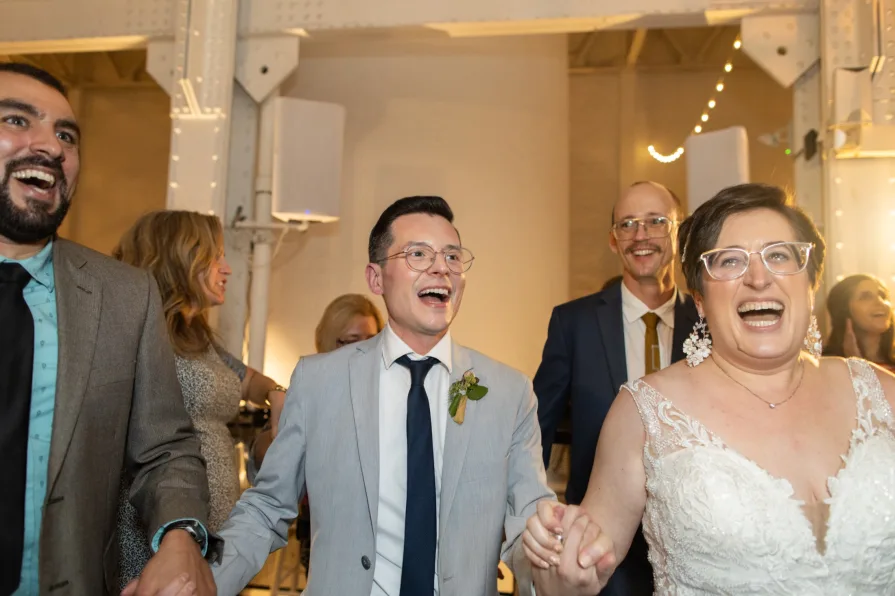 A queer, biracial couple during the Hora at an Old City wedding at Power Plant.