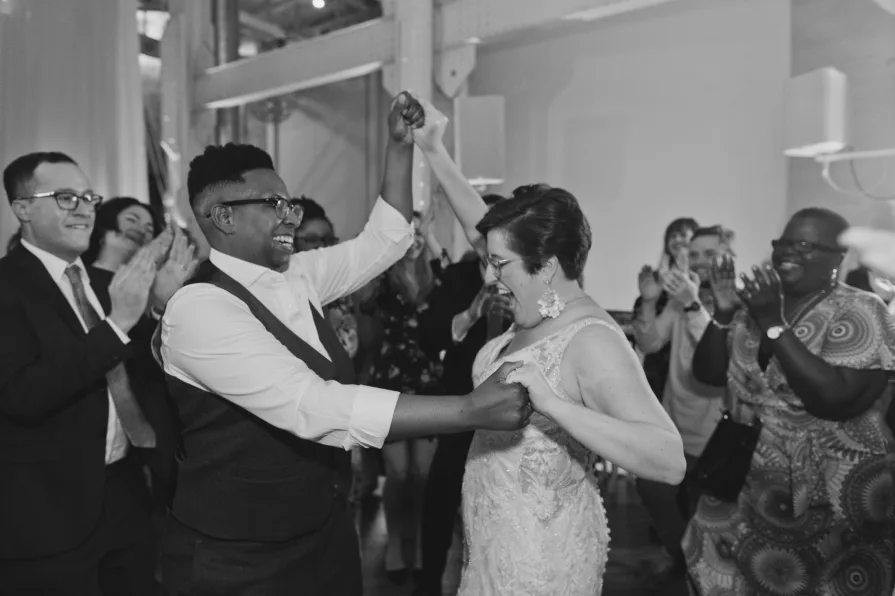A queer, biracial couple dancing at a reception during an Old City wedding at Power Plant.