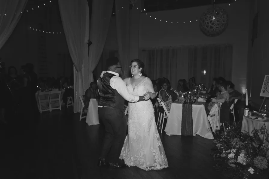 A queer, biracial couple dancing at a reception during an Old City wedding at Power Plant.