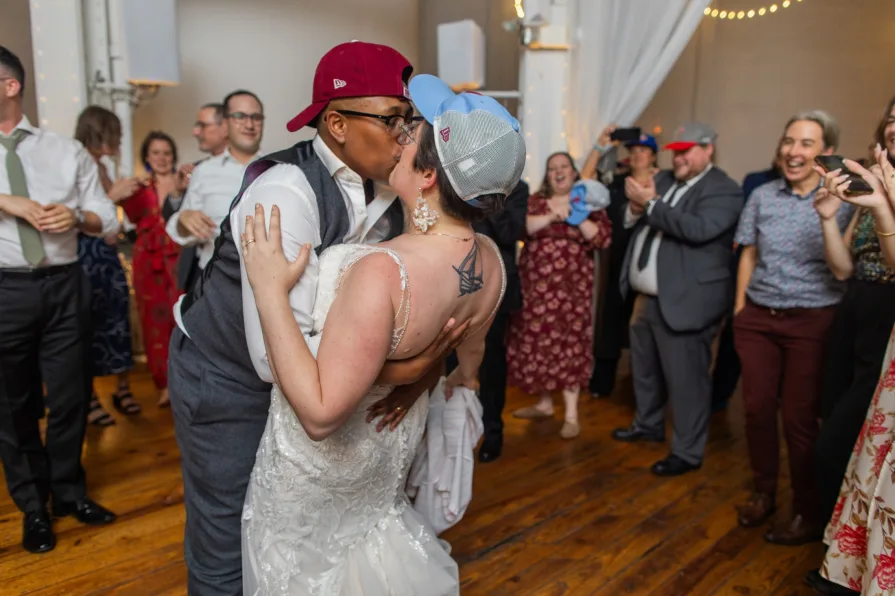 Wedding guests with Phillies gear dance to "Dancing On My Own" at a reception.