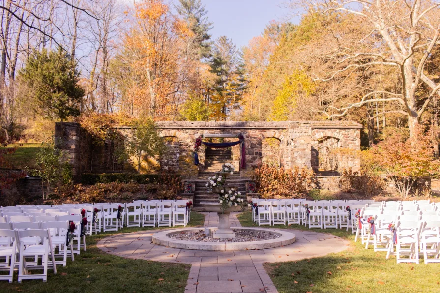 A fall wedding ceremony outside at Parque at Ridley Creek State Park