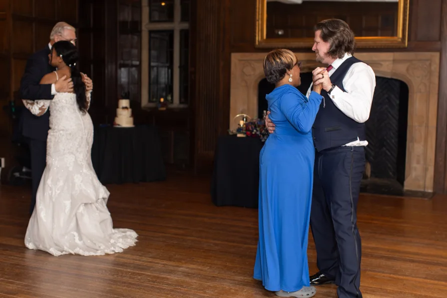 A parent dance with combined families at a wedding reception.
