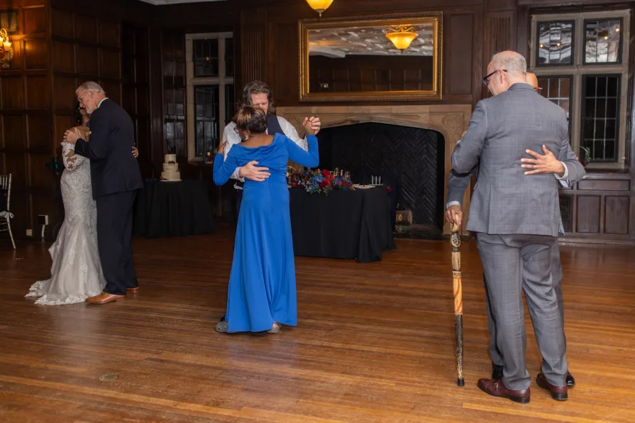 A parent dance with combined families at a wedding reception.