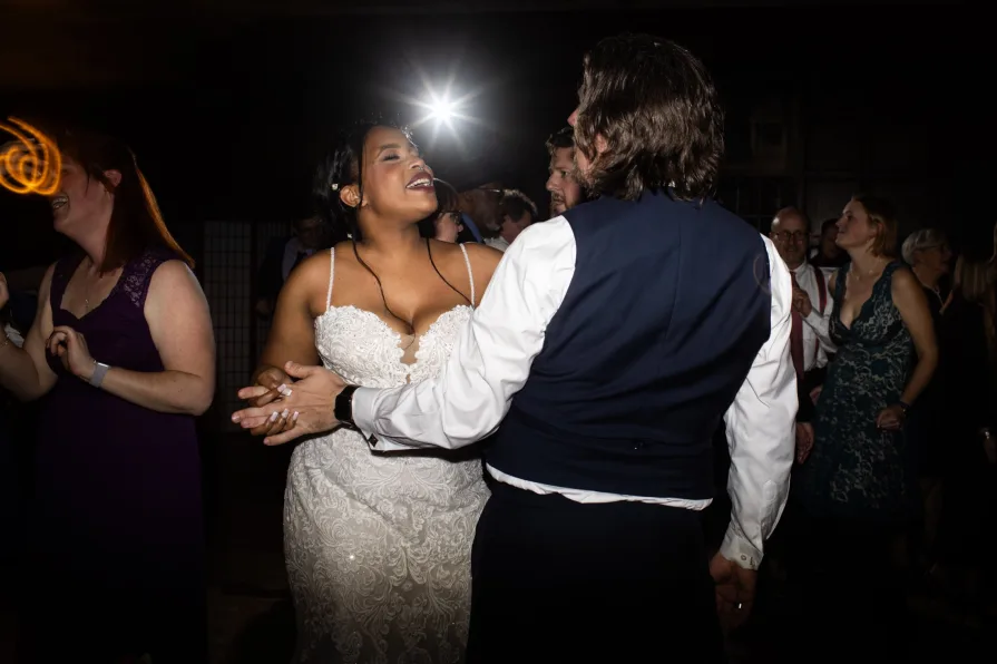The marriers dancing at their reception happily.