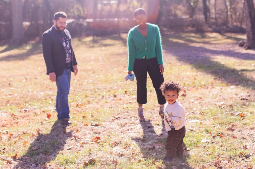 A family of three in their backyard in the Philadelphia suburbs for their family photo session.