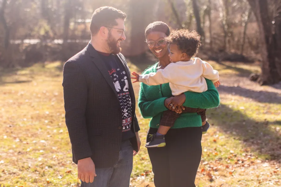 A family of three in their backyard in the Philadelphia suburbs for their family photo session.