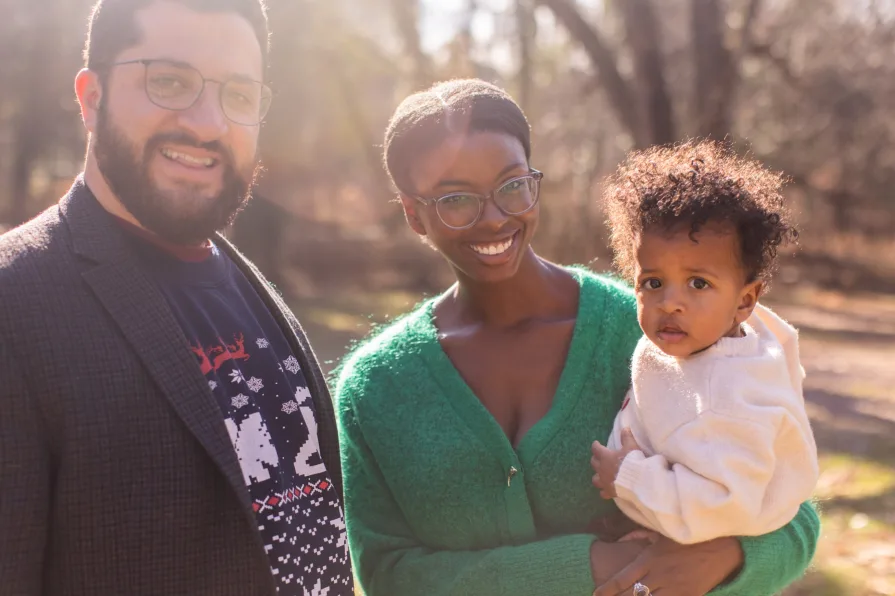 A family of three in their backyard in the Philadelphia suburbs for their family photo session.