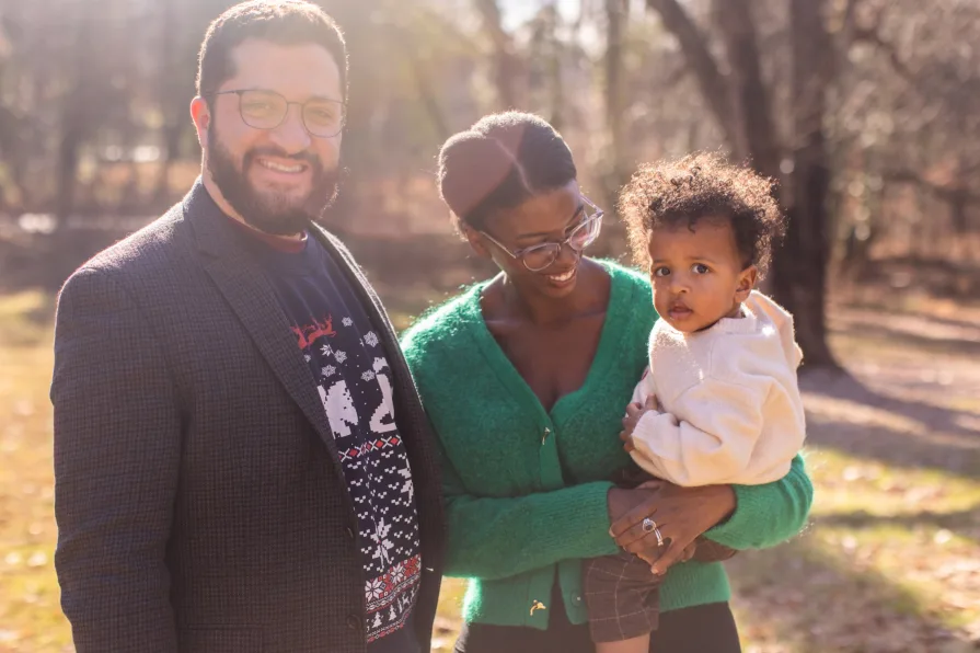 A family of three in their backyard in the Philadelphia suburbs for their family photo session.