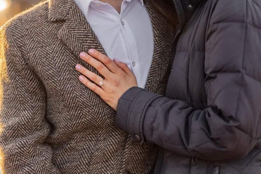 A closeup of a hand wearing an engagement ring.