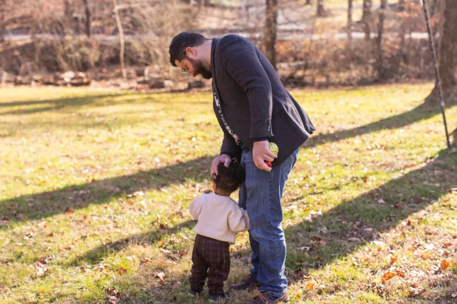 Forest is being comforted by his father in their backyard.