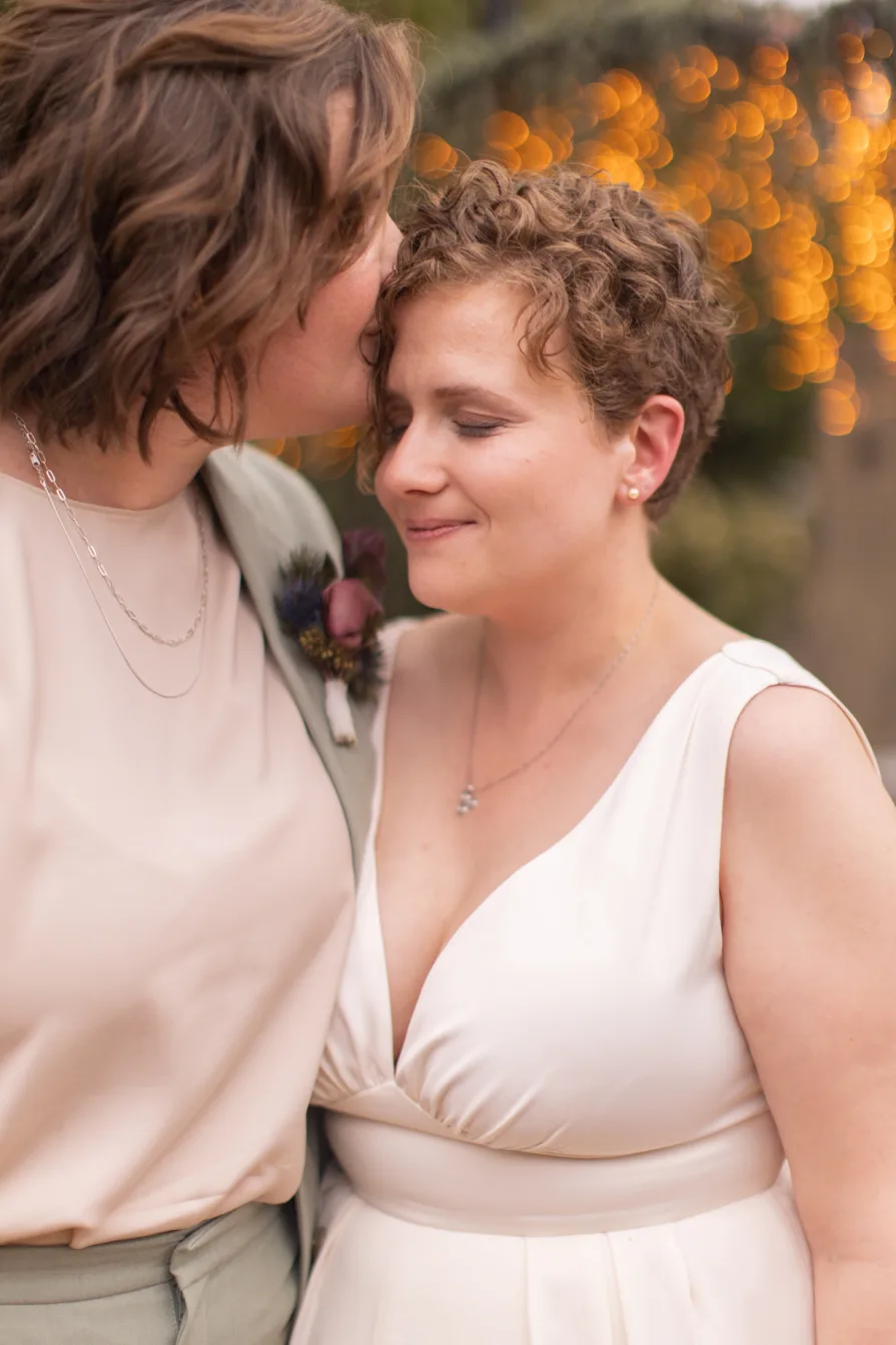 Queer marriers dance outside in the rain at Terrain at Styer's in Glen Mills for their wedding photos.