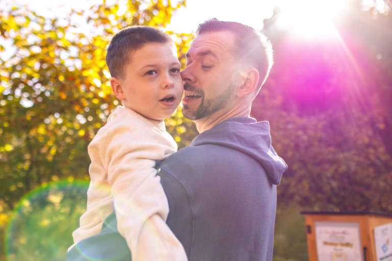 A dad and son at Morris Arboretum during a family photo session in the Philadelphia area.